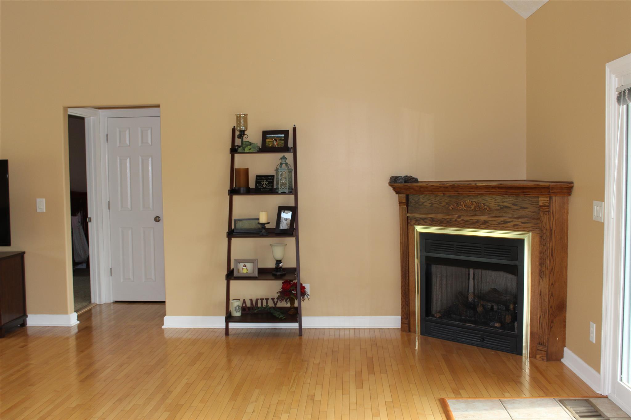 112 Big Springs Road Lebanon, TN 37087 - Photo 7 of 29 a view of an empty room with wooden floor and a fireplace