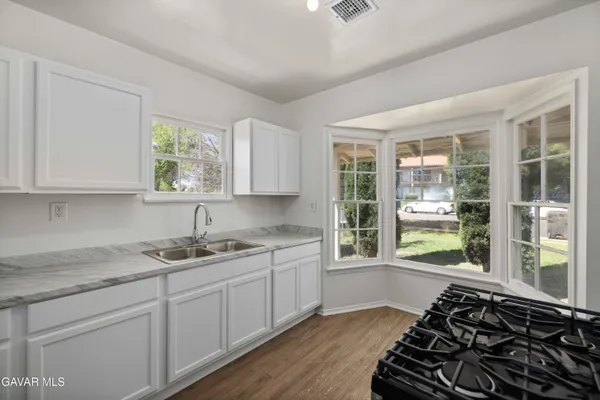 a kitchen with sink a window and appliances
