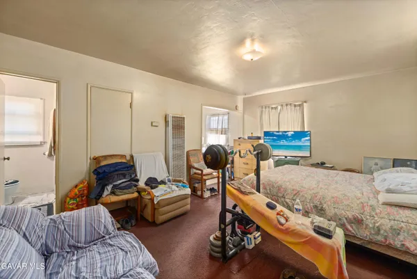 a bedroom with furniture and a gym equipment