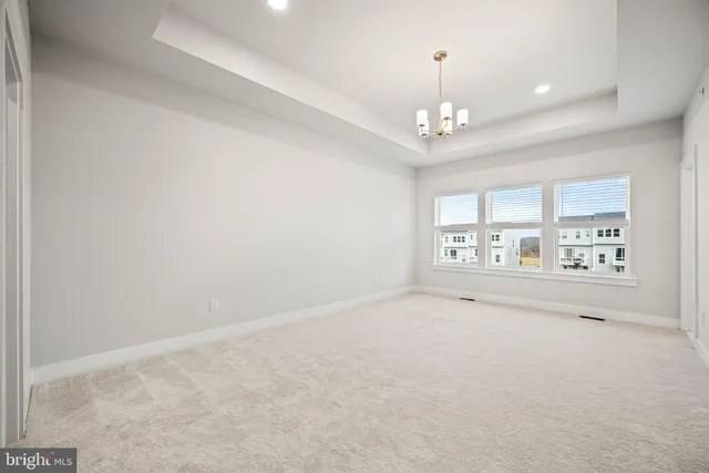 a view of an empty room with a chandelier