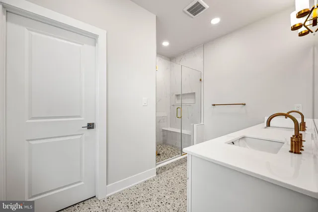 a bathroom with a sink a mirror and a light fixture