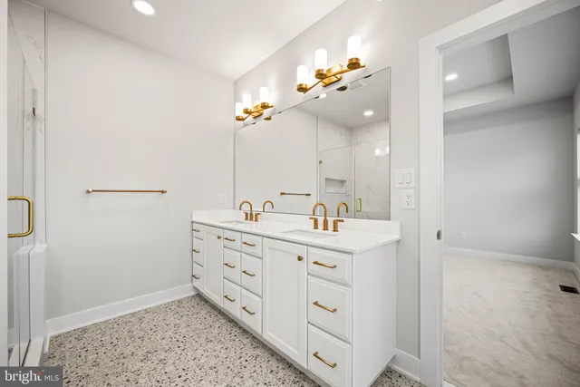a bathroom with a double vanity sink a mirror and a bathtub with shower