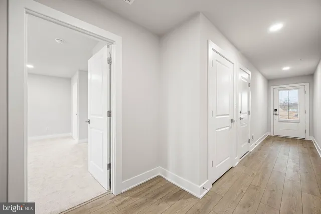 a view of hallway with wooden floor