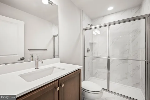 a bathroom with a sink toilet and a mirror