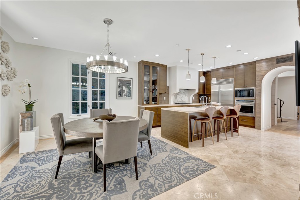 16 Eucalyptus Newport Coast, CA 92657 - Photo 13 of 38 a dining room with furniture a chandelier and kitchen view