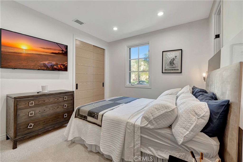 16 Eucalyptus Newport Coast, CA 92657 - Photo 22 of 38 a bedroom with a bed and a flat screen tv