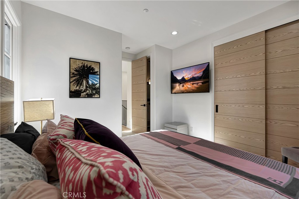 16 Eucalyptus Newport Coast, CA 92657 - Photo 27 of 38 a bedroom with a bed and a painting on the wall