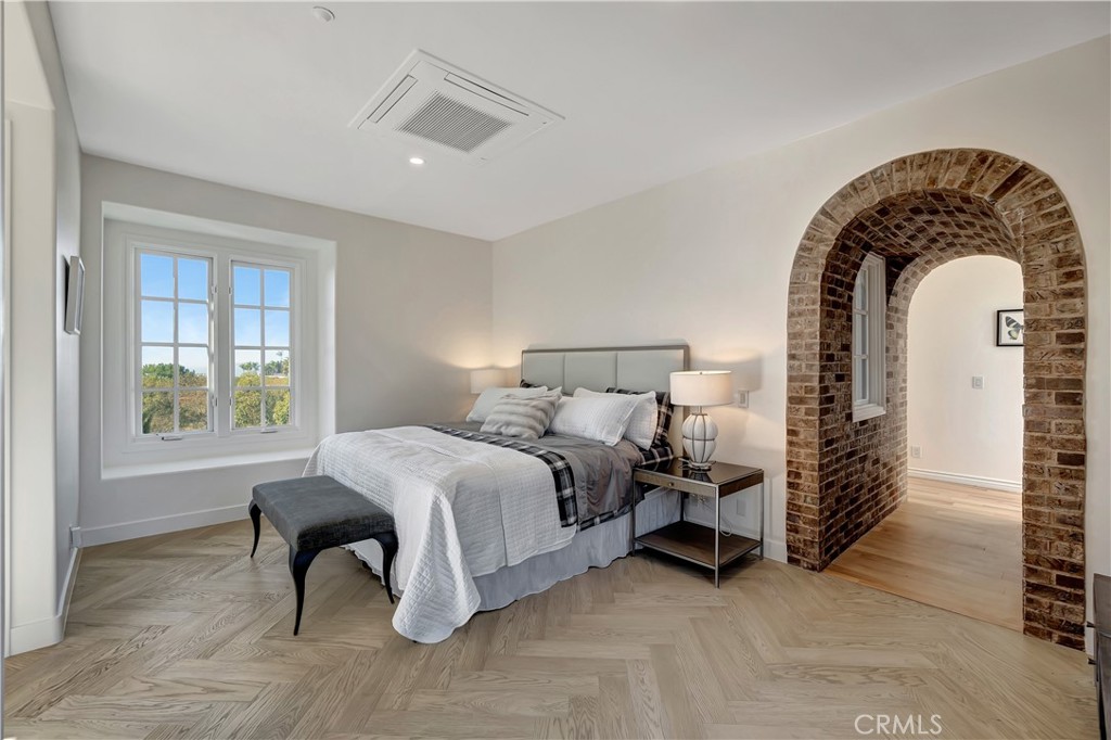 16 Eucalyptus Newport Coast, CA 92657 - Photo 28 of 38 a spacious bedroom with a bed a table and windows