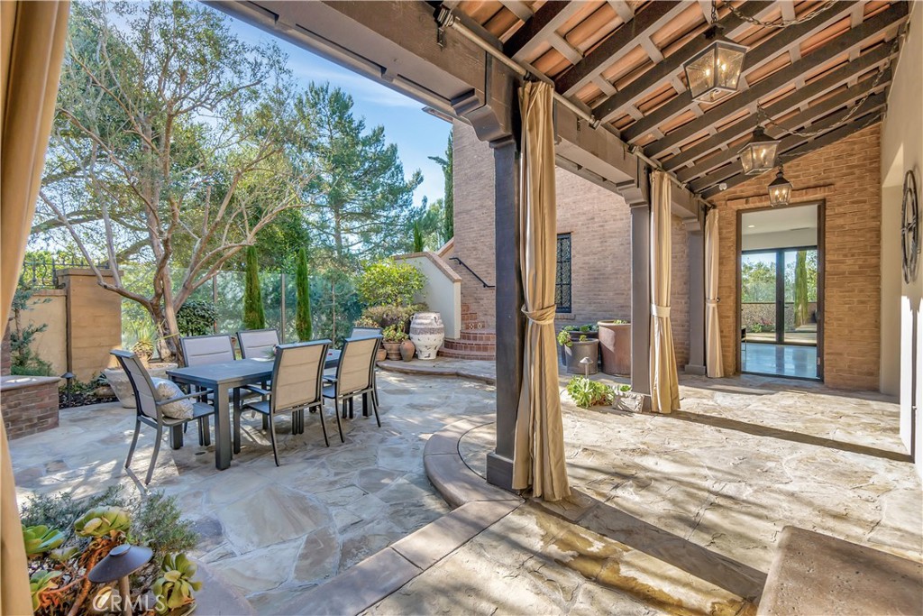 16 Eucalyptus Newport Coast, CA 92657 - Photo 3 of 38 a view of a patio with table and chairs and floor to ceiling window