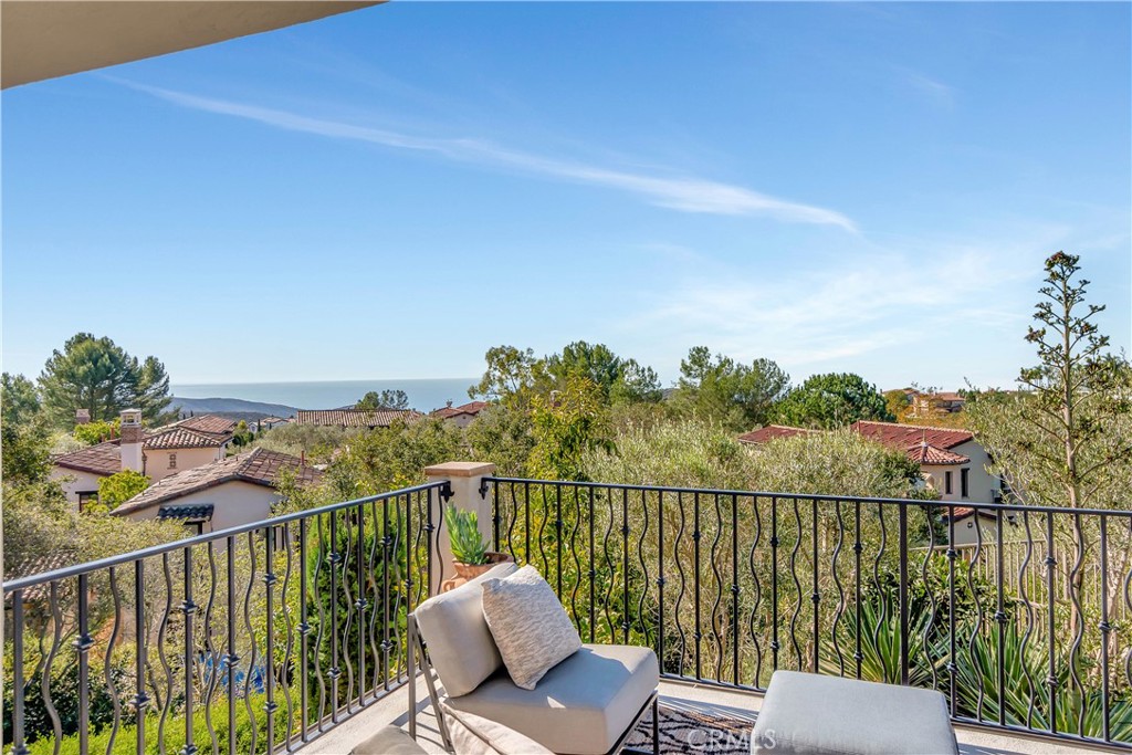 16 Eucalyptus Newport Coast, CA 92657 - Photo 36 of 38 a view of a balcony with wooden floor chairs and iron fence