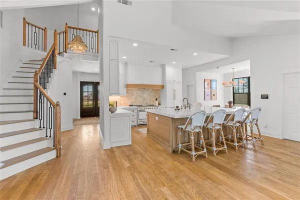 a large kitchen with a table and chairs