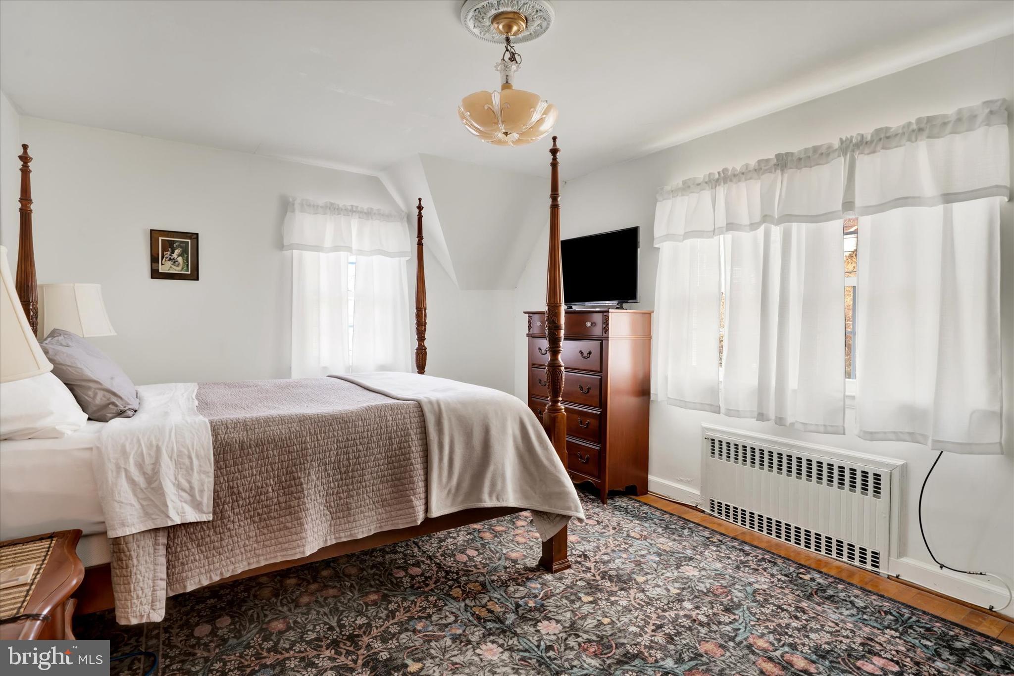 1711 Alsace Road Reading, PA 19604 - Photo 25 of 45 a bedroom with a bed a window and a chandelier
