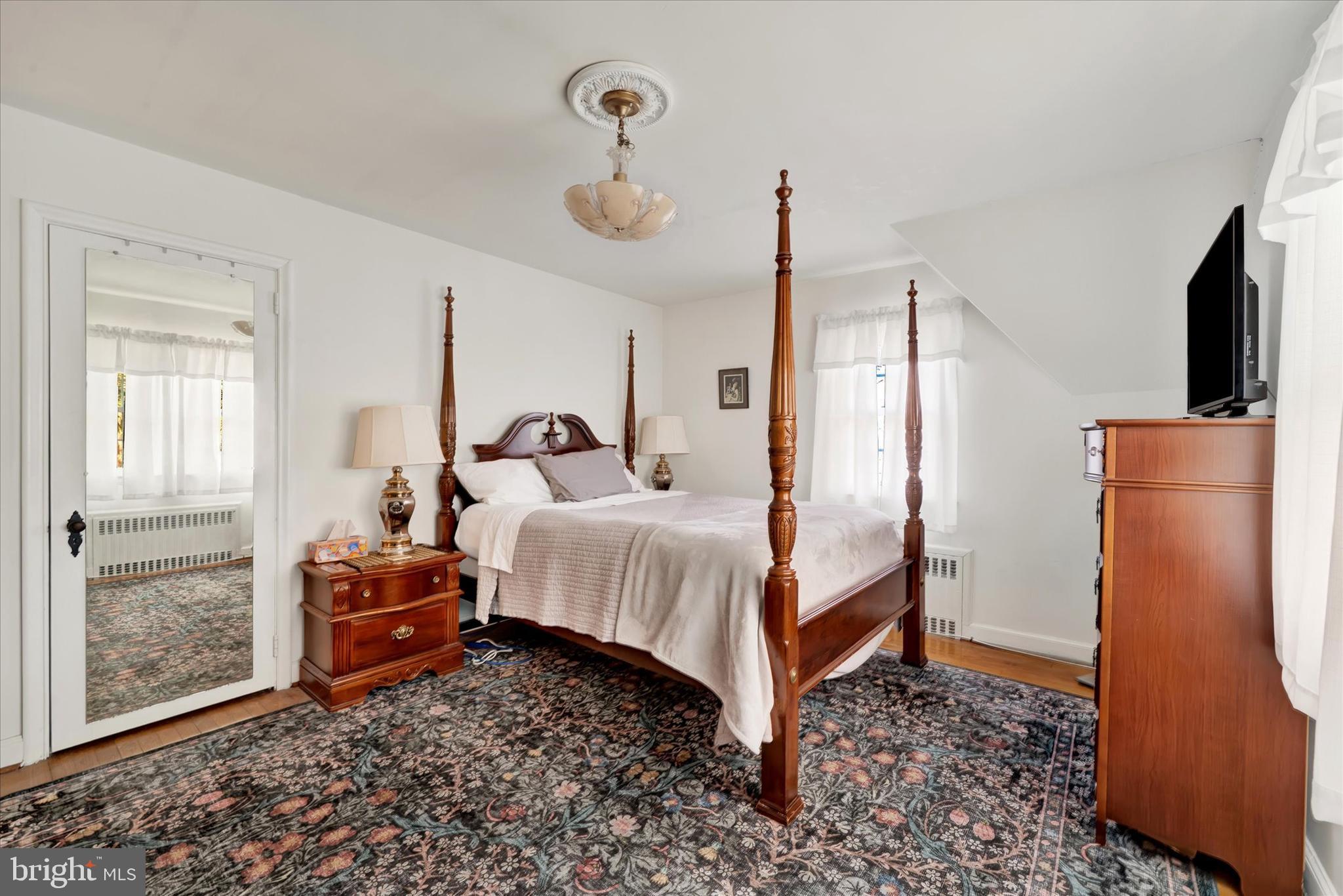 1711 Alsace Road Reading, PA 19604 - Photo 26 of 45 a bedroom with a bed and wooden floor