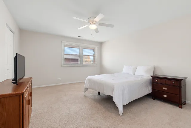 a spacious bedroom with a bed and a window