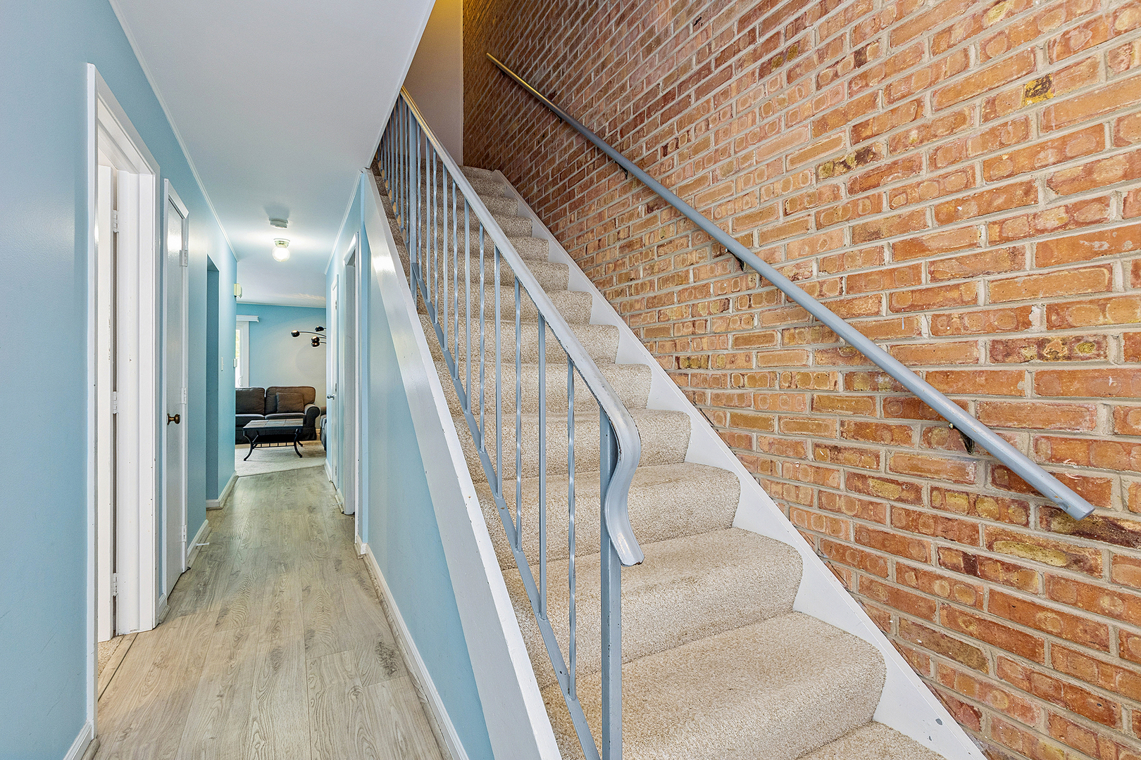 7682 South 88 Court Justice, IL 60458 - Photo 4 of 21 a view of staircase with lots of frames on wall and a large window