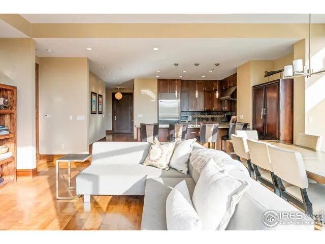 a living room with stainless steel appliances kitchen island granite countertop furniture and a large window