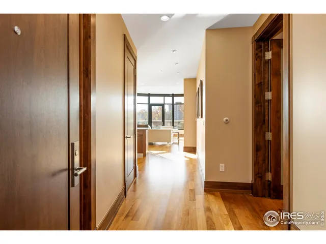 a picture of an empty room with wooden floor and a window