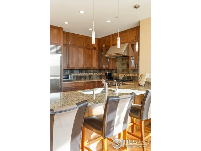 a kitchen with stainless steel appliances granite countertop a sink and cabinets