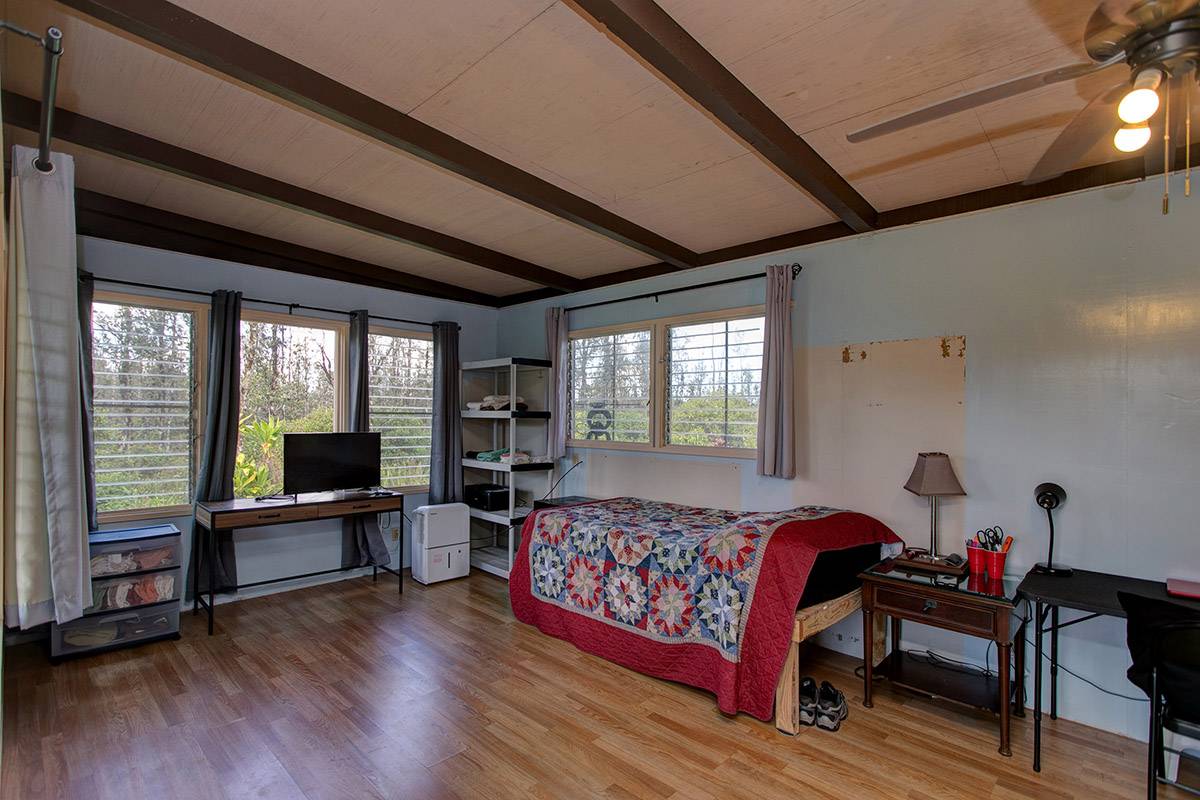 16-2041 Opeapea Road Pahoa, HI 96778 - Photo 15 of 26 a bedroom with furniture wooden floor and windows