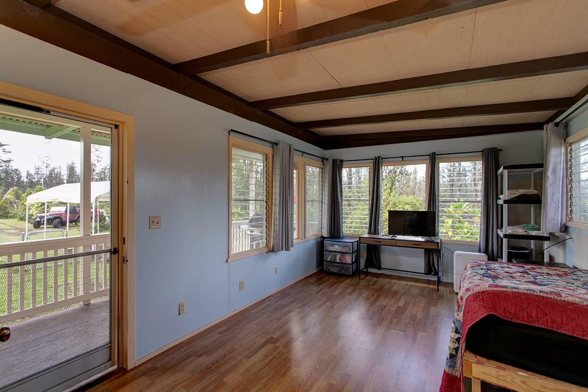 16-2041 Opeapea Road Pahoa, HI 96778 - Photo 18 of 26 a living room with furniture stove and wooden floor