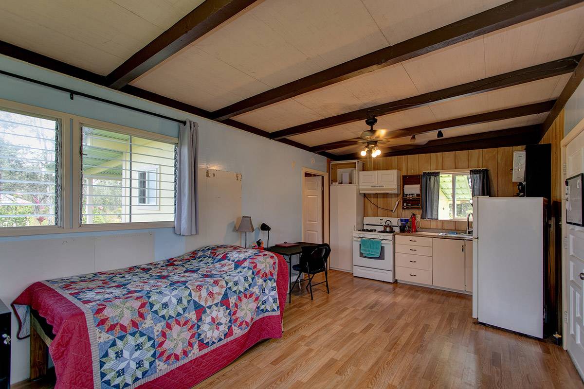 16-2041 Opeapea Road Pahoa, HI 96778 - Photo 19 of 26 a bed room with a bed and a large window