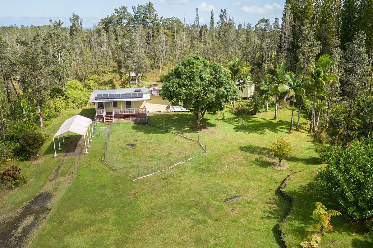 16-2041 Opeapea Road Pahoa, HI 96778 - Photo 3 of 26 a view of a residential apartment building with a yard
