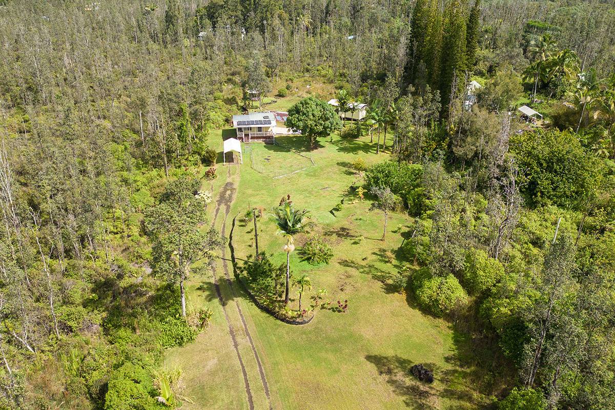 16-2041 Opeapea Road Pahoa, HI 96778 - Photo 5 of 26 a view of residential house with swimming pool and lawn chairs