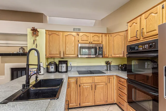 a kitchen with stainless steel appliances granite countertop a refrigerator and a stove