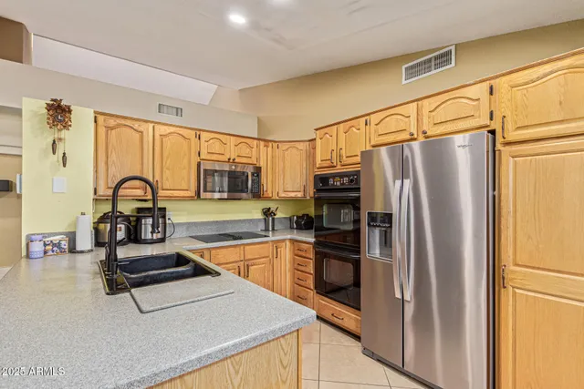 a kitchen with a sink and wooden cabinets