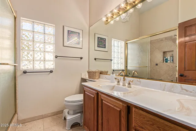 a spacious bathroom with a granite countertop sink and a large mirror
