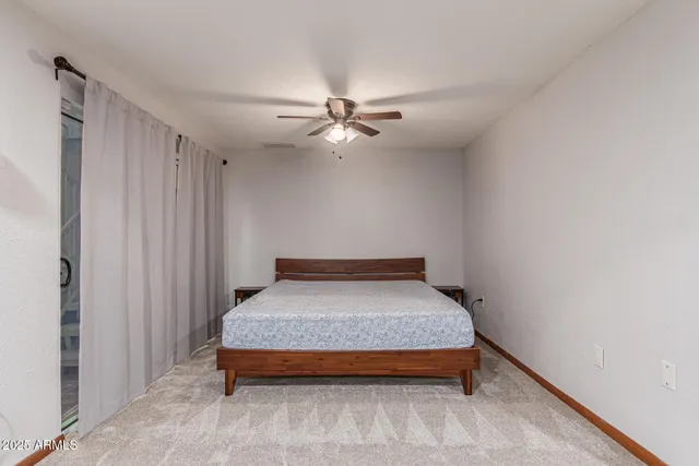 a view of a patio with chairs and a table under an umbrella