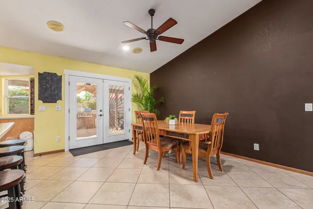 a view of a dining room with furniture and a chandelier