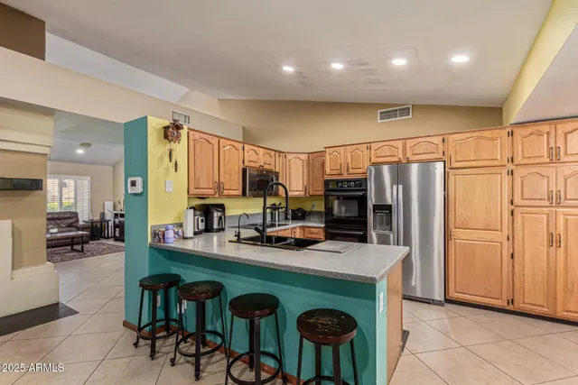 a kitchen with granite countertop a sink stainless steel appliances and cabinets
