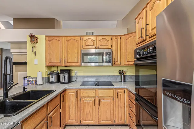 a kitchen with stainless steel appliances granite countertop a sink and cabinets