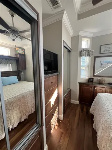 a bedroom with furniture and a flat screen tv