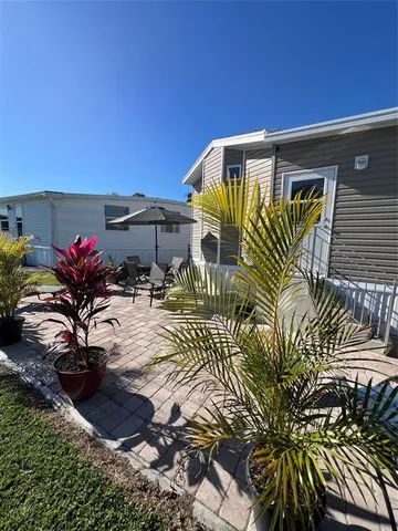 a backyard of a house with table and chairs