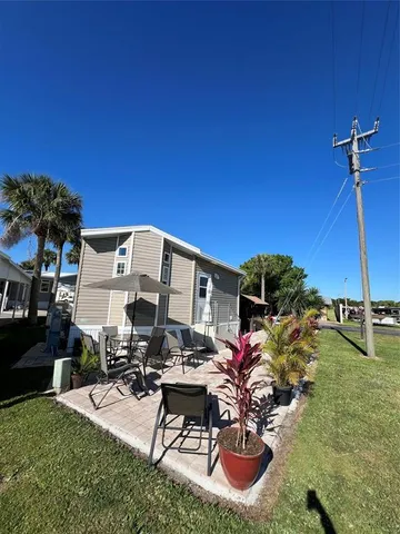 a view of a patio with chairs and plants