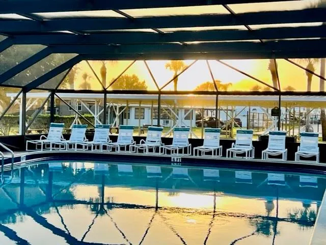 a view of a patio with table and chairs under an umbrella