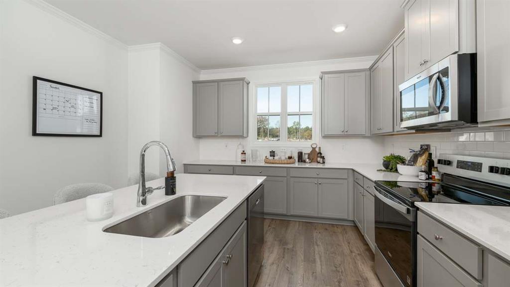 691 Alburgh Alley Mableton, GA 30126 - Photo 16 of 37 a kitchen with a sink stove top oven and cabinets