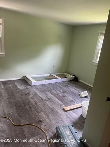 a view of a room with wooden floor