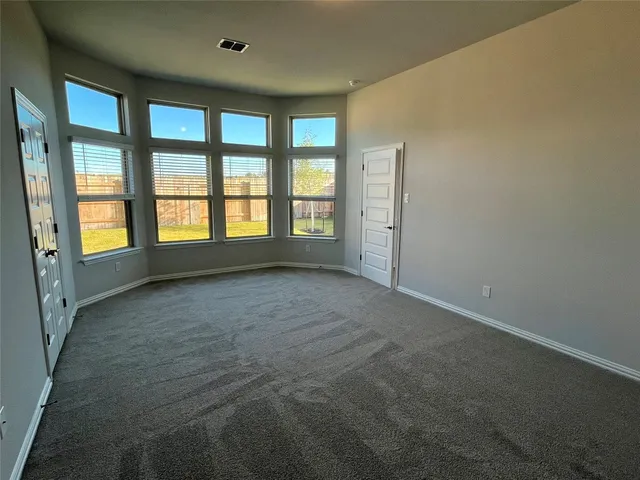 an empty room with large windows