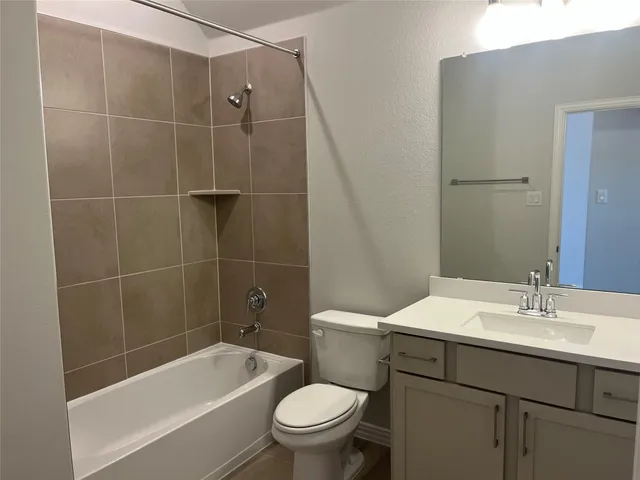 a bathroom with a sink mirror toilet and bathtub