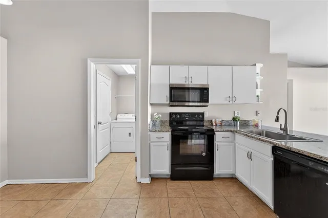 a kitchen with granite countertop a granite counter tops and a view of living room