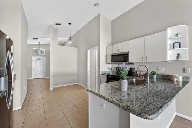 a view of a room with a ceiling fan and a window