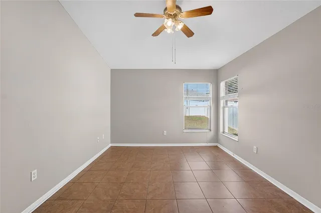 an empty room with fan and entrance