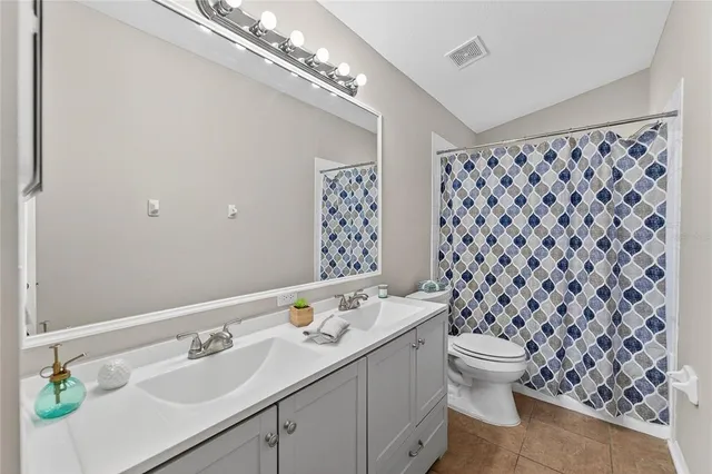 an empty room with closet and a chandelier fan