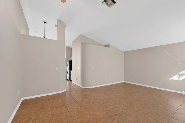 a large kitchen with a refrigerator and a stove top oven