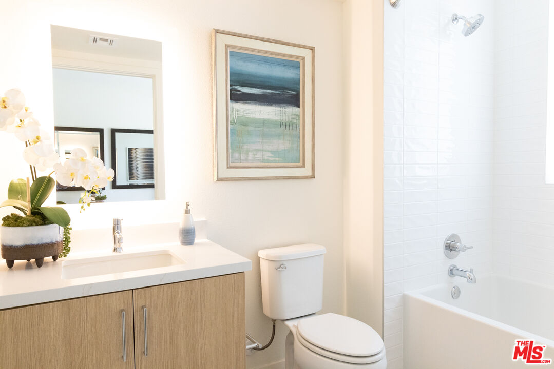 7566 West Sunset Boulevard, Unit 411PHE Los Angeles, CA 90046 - Photo 11 of 15 a bathroom with a sink a toilet and shower