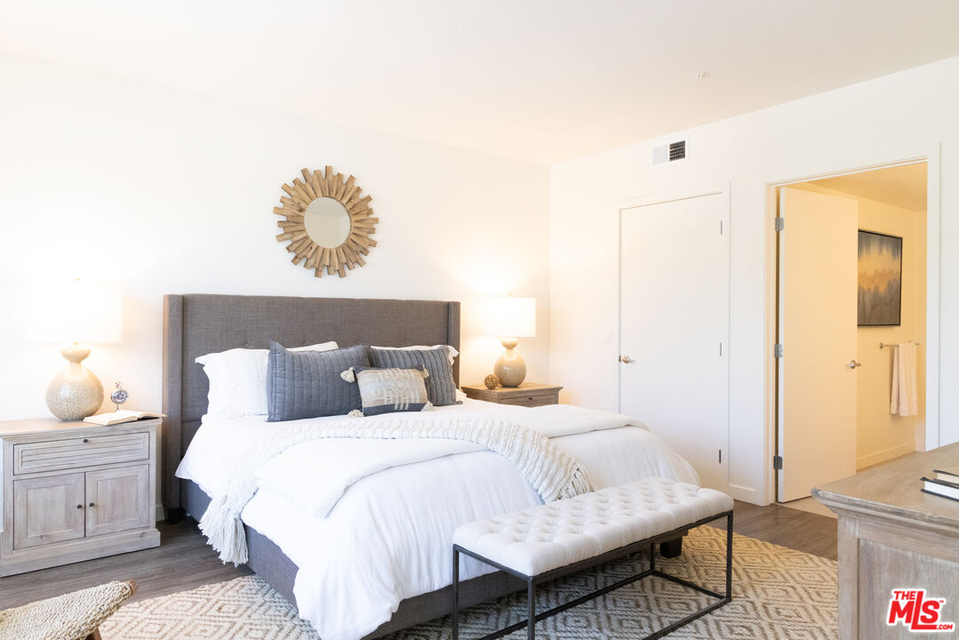 7566 West Sunset Boulevard, Unit 411PHE Los Angeles, CA 90046 - Photo 6 of 15 a bedroom with a bed and wooden floor
