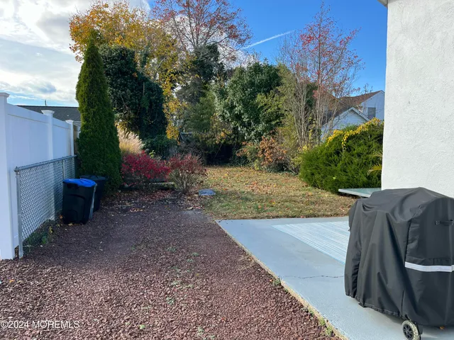 a view of a patio with couches and a fireplace